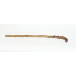 A walking stick, the handle in the form of a pointer,