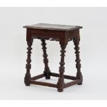 A 17th Century oak joint stool with shaped rails,