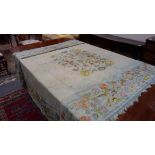 A 17th/18th Century silk needlework coverlet sewn with flowerheads, approximately 9ft x 7ft