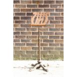 An iron music stand with lyre-shaped rest, adjustable,