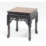 A Chinese hardwood stand, the square top on carved frieze and legs,