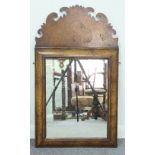 A walnut mirror, the fret work cresting and bolection frame inlaid with geometric boxwood lines,