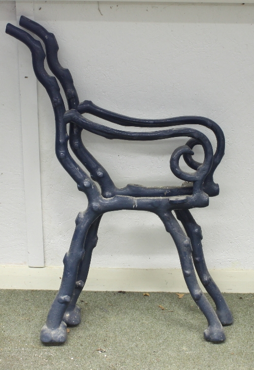 A pair of iron garden bench ends, painted green,