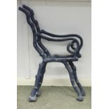 A pair of iron garden bench ends, painted green,