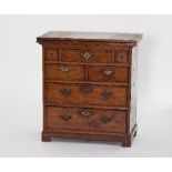 A small George II 18th Century walnut batchelor's chest, the hinged top above three short, two short