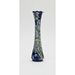 A Moorcroft MacIntyre florian ware vase of narrow trumpet shape with frilled rim, tube lined with