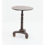 A Georgian rosewood and simulated rosewood occasional table, the circular top on a carved and turned