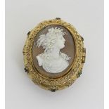 A gilt metal oval pill box, the cover set with a cameo depicting a bacchanal female in profile,