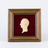 An ivory relief bust of a gentleman facing left, mounted,