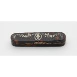 A tortoiseshell patch box finely inlaid with silver coloured flowers and foliage and central urn