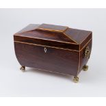 A Regency rosewood sarcophagus shaped tea caddy with ring handles to the sides,