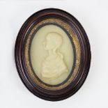 A wax portrait silhouette, circa 1780, of a young girl, bust length,