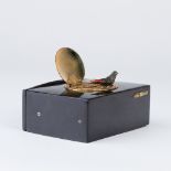 A Swiss singing bird box, early 20th Century, faux tortoiseshell cased, the top with oval hinged