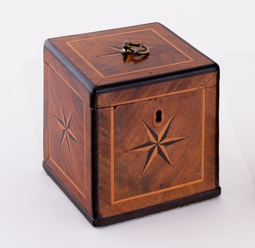A George II walnut square tea caddy with ring handle to the top and inlaid a five point star to top,