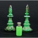 A pair of late 19th Century green glass scent bottles of octagonal tapered form with pointed