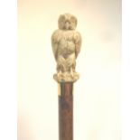 An umbrella with a finely carved ivory owl handle