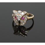 A ruby and diamond owl-mask ring, the mask set with diamonds and ruby eyes,