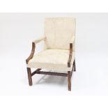 A George III style mahogany Gainsborough type armchair with carved arm supports and legs