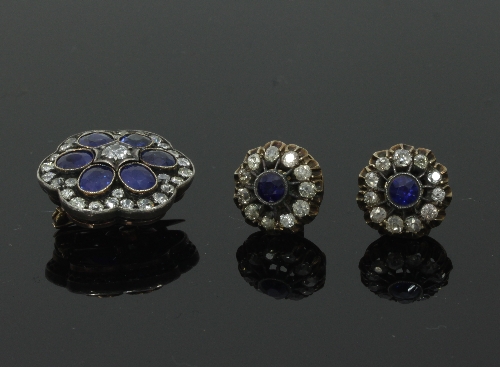 A sapphire and diamond cluster brooch/pendant, of flowerhead shape,