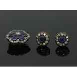 A sapphire and diamond cluster brooch/pendant, of flowerhead shape,