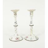 A pair of Bilston enamel candlesticks, circa 1780, decorated floral sprays on a white ground, 25.