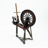 A spinning wheel, with turned supports,