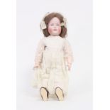 A Kammer & Reinhardt bisque head doll with painted eyes, closed mouth and jointed limbs, number 114,