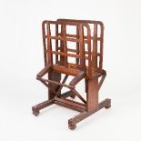 A 19th Century oak folio stand, with adjustable ratchet mechanism on bun feet with castors,