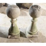 A pair of baluster columns with ball finials,