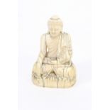A Chinese carved ivory figure of Guanyin, Qing Dynasty, modelled in a seated position, 8.5cm high
