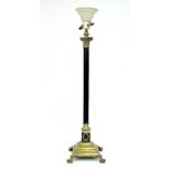 A Corinthian column brass and bronzed standard lamp on square stepped base and lion paw feet,