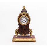A 19th Century French tortoiseshell and brass boulle type eight-day mantel clock,