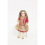 A Bebe Steiner bisque head doll with fixed eyes, closed mouth, pierced ears and jointed limbs,