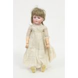 A Kammer & Reinhardt bisque head doll with weighted eyes, closed mouth and jointed limbs, numbered