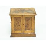 An Edwardian oak and pollard oak table cabinet,