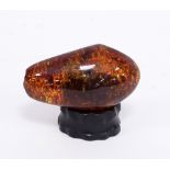 A large piece of amber, containing vegetable matter, 11cm wide, approximately 195gm,