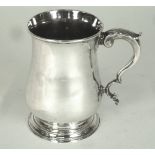 A George III silver mug, William & John Deane, London 1764, of baluster form with leaf capped scroll