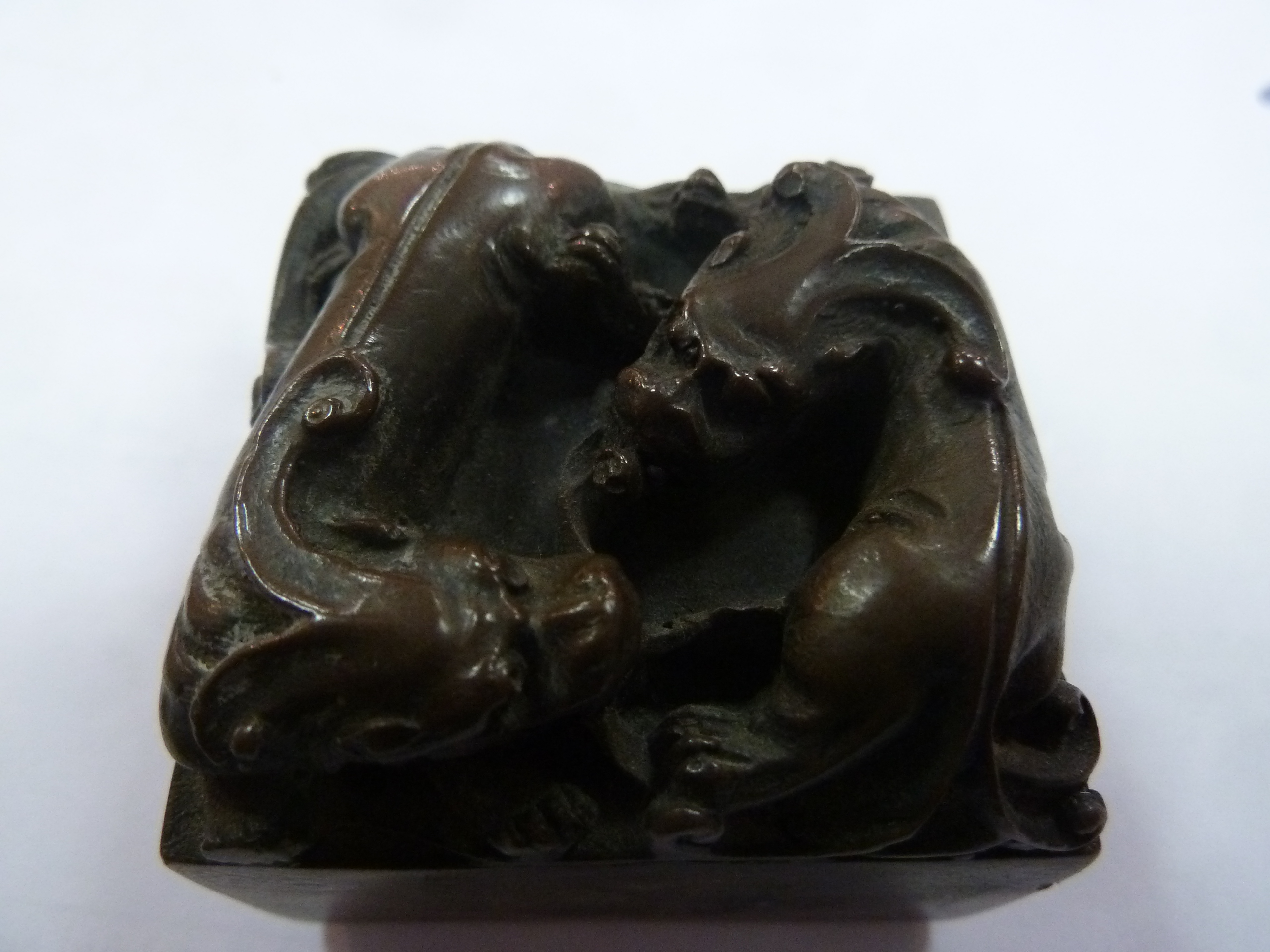 A Chinese carved soapstone desk seal, surmounted by a toad, 6cm wide and a bronze paperweight - Image 4 of 4