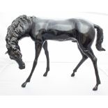 A large bronze figure of a standing horse,