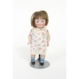 A 'Googly' bisque doll with weighted eyes and moveable limbs in a cream floral dress, numbered 189/