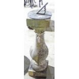 A reconstituted stone sundial with baluster column support,