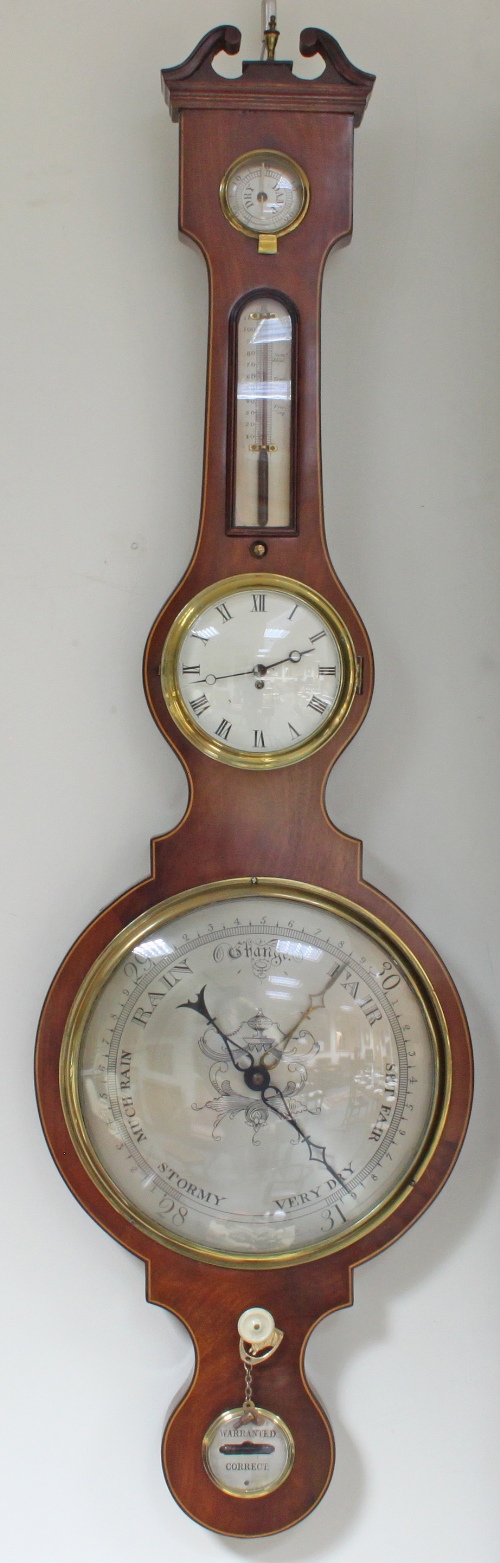 A fine five-piece mahogany wheel barometer, with humidity gauge, thermometer, clock and level,
