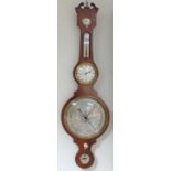 A fine five-piece mahogany wheel barometer, with humidity gauge, thermometer, clock and level,