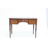 An early 19th Century mahogany dressing table with three drawers on turned tapering legs,