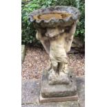 A reconstituted stone bird bath with scallop bowl on a cherub support, 64cm high Condition Report: