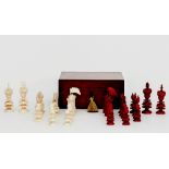 A red stained and natural ivory chess set by Charles Hastilow, the kings with jewelled Maltese cross