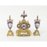A gilt metal and porcelain mounted eight-day clock set, the clock with urn finials and female bust