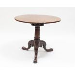 A George III mahogany table on a carved and turned column with tripod support,