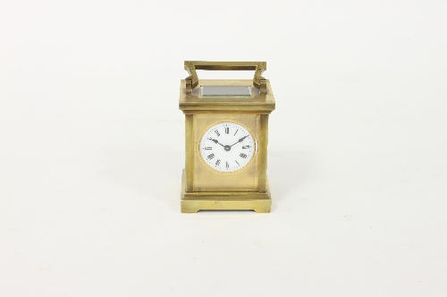 A gilt brass carriage timepiece with circular enamel dial and eight-day movement, 13.