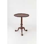 A George III mahogany tripod table, the piecrust and shell carved top on fluted and spiral fluted